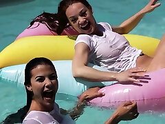 Lesbian girlfriends having fun at a pool