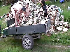 Dark haired German lady making her slaves chop wood
