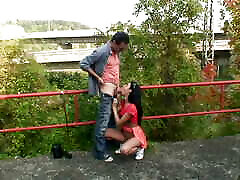 Beautiful dark haired teen pleasing a old cock in public